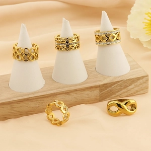 Golden infinity and heart cutout rings with sparkling zircon inlay set on display