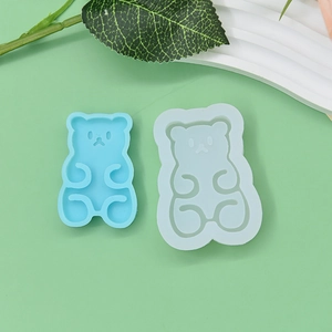 Detail of 2-piece cute bear silicone molds for chocolate and DIY crafts on green background