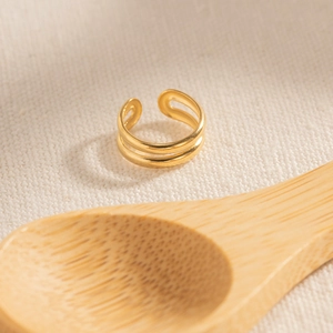 Elegant double-layered 18k gold plated stainless steel open ring on a textured fabric