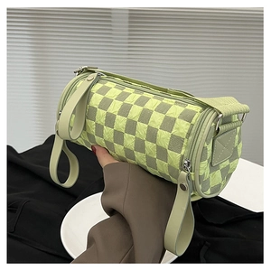 Close-up of checkerboard cylinder bag with wrinkled texture in green and grey