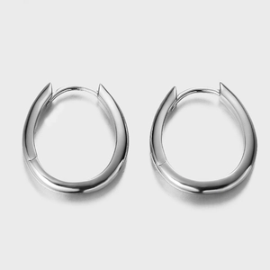 Macro detail of polished 925 sterling silver oval hoop earrings with sleek metal finish