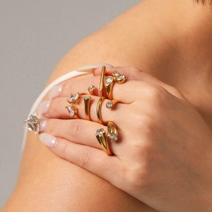 18K gold plated stainless steel open rings with zircons worn by model on neutral background
