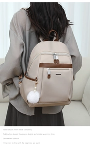 Detailed back view of a beige and brown fashion backpack with a plush pompom accessory