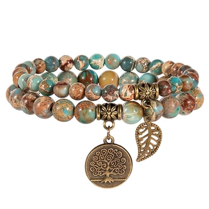 Detailed macro view of multi-layer stone beads with Tree of Life and leaf charms