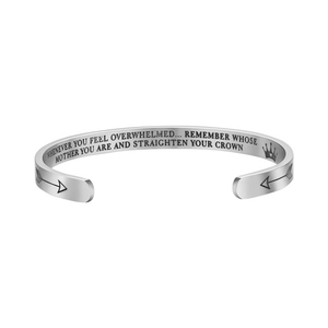 Detailed engraving on silver stainless steel cuff bracelet with arrow pattern accents