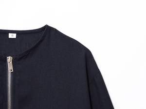 Detail of dark knit jacket with silver metal zipper and S size tag on white background