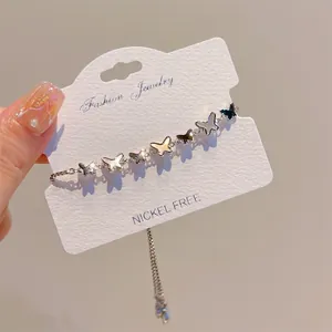 Silver adjustable butterfly charm bracelet with black and white iridescent shells