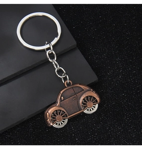 Close-up of bronze vintage beetle car keychain with durable metal ring and chain
