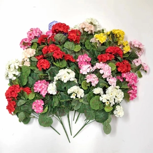 Detailed top view of multi-colored artificial geranium silk flowers in various vibrant shades