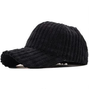 Detailed texture of black corduroy fabric on a stylish autumn-winter baseball cap