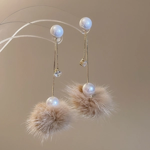 Details von eleganten Tropfenohrringen mit Pelzkugeln, Kunstperlen und Kristallen