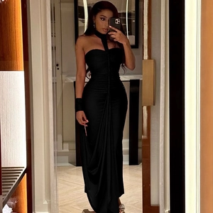 Close-up of ruched black long dress featuring a backless halter neckline and slim fit design
