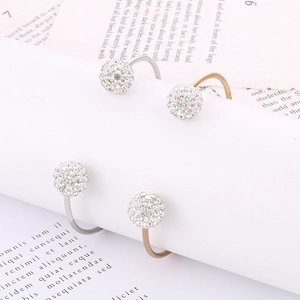 Detailed view of C-shaped titanium steel bracelet with sparkling rhinestone-encrusted balls