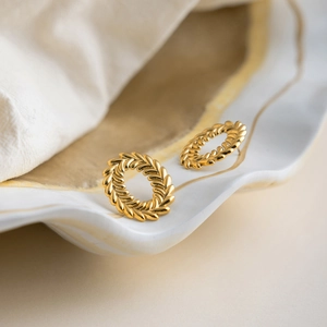 Detail showing vintage oval 18K gold plated earrings with wheat leaf textured metal finish