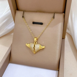 Macro view of broken heart pendant with pavé set cubic zirconia on a gold chain