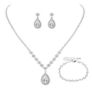 Macro detail of silver bridal jewelry set with pear-cut cubic zirconia and drop pendants