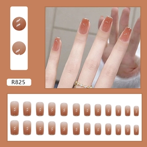 French gradient press-on nails in caramel orange with fine silver glitter accents