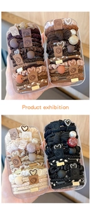 Detail of four sets of high-elastic hair ties in beige, brown, and black storage boxes