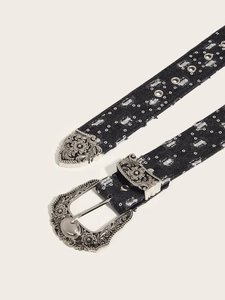 Detail of black denim belt with vintage floral engraved metal buckle and silver studs