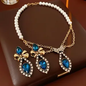 Vintage jewelry set with pearl necklace, blue gemstone teardrops and bow earrings