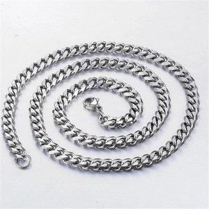 Detailed top view of a spiral-coiled silver Cuban link chain with a secure lobster clasp