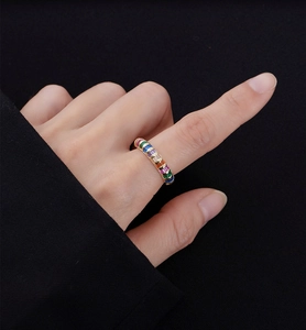 Close-up of a 14k gold-plated 925 silver ring featuring vibrant rainbow baguette crystals