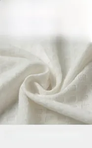 Macro detail of white waffle weave fabric showing breathable grid texture and soft finish