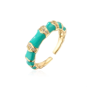 Detail of bamboo joint ring with green enamel and sparkling zircon stones in gold