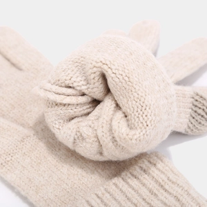 Close-up of oatmeal knit gloves with ribbed cuffs and touchscreen conductive fingertips