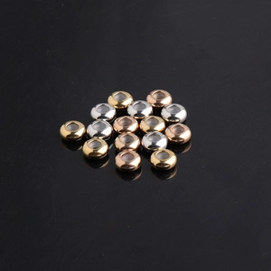 Macro shot of gold silver and rose gold stainless steel stopper beads with rubber lining