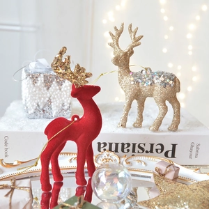 Red flocked and golden sequined Christmas reindeer ornaments for holiday tree decoration