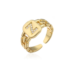 Detail of adjustable gold ring with Z-letter zircon paving and chain-link band design