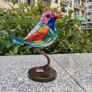 Colorful bird sculpture on metal stand with round base for home garden decor
