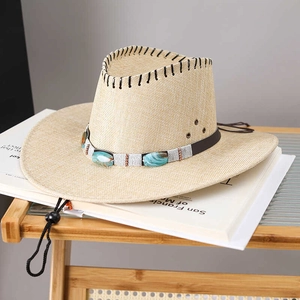 Detail of western straw cowboy hat with turquoise band and adjustable wind rope