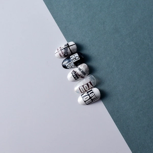 Detailed view of 5D embossed nail stickers featuring black and white LOVE YOU lettering