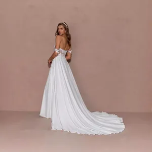 Elegant white lace wedding dress with a deep V-neck, long train, and floral embroidery
