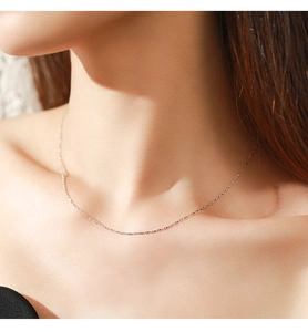 Close-up of minimalist S925 sterling silver heart snake chain necklace on a female model