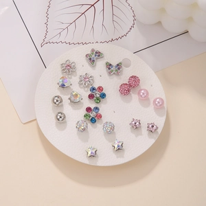 Detailed set of 12 mixed stud earrings with pearls and crystals on a round white card