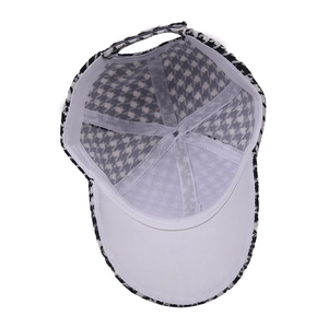Houndstooth baseball cap in black and white with an adjustable strap and curved brim