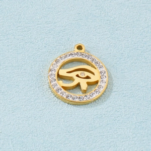 Detailed close-up of a gold Eye of Horus pendant featuring sparkling zircon inlay