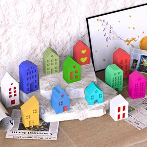 Creative display of colorful mini house ornaments in Nordic style on white textured stones