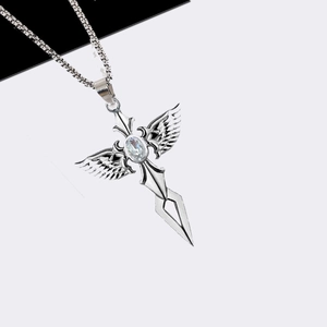 Detail of silver stainless steel cross pendant with wings and oval gemstone center