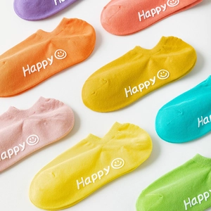 Close-up of colorful pastel low-cut socks with Happy smiley face and non-slip texture