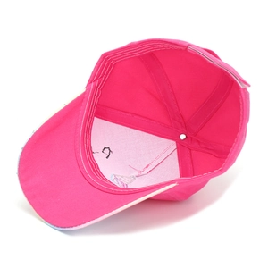 Detailed view of internal stitching and lining on a bright pink unicorn baseball cap