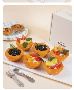 Detailed close-up of realistic fruit egg tart models with assorted berry and cream toppings