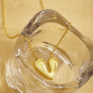 Irregular chunky heart necklace with a polished gold finish on modern minimalist chain
