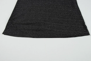 Detailed macro view of black glitter fabric with silver sequins on a dress hemline