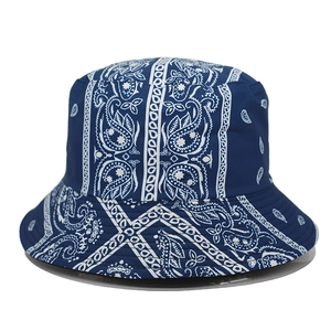 Detailed view of the dark blue bucket hat featuring classic white paisley patterns