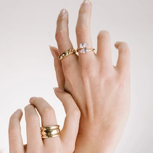 Three-piece gold ring set featuring spiral twist, double zircon, and thick layered band