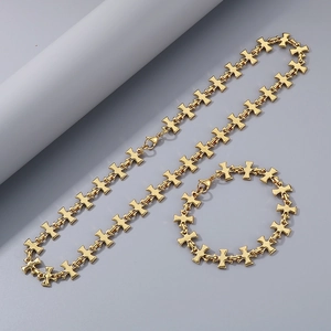Detail of gold cross-link titanium steel jewelry set with necklace and bracelet